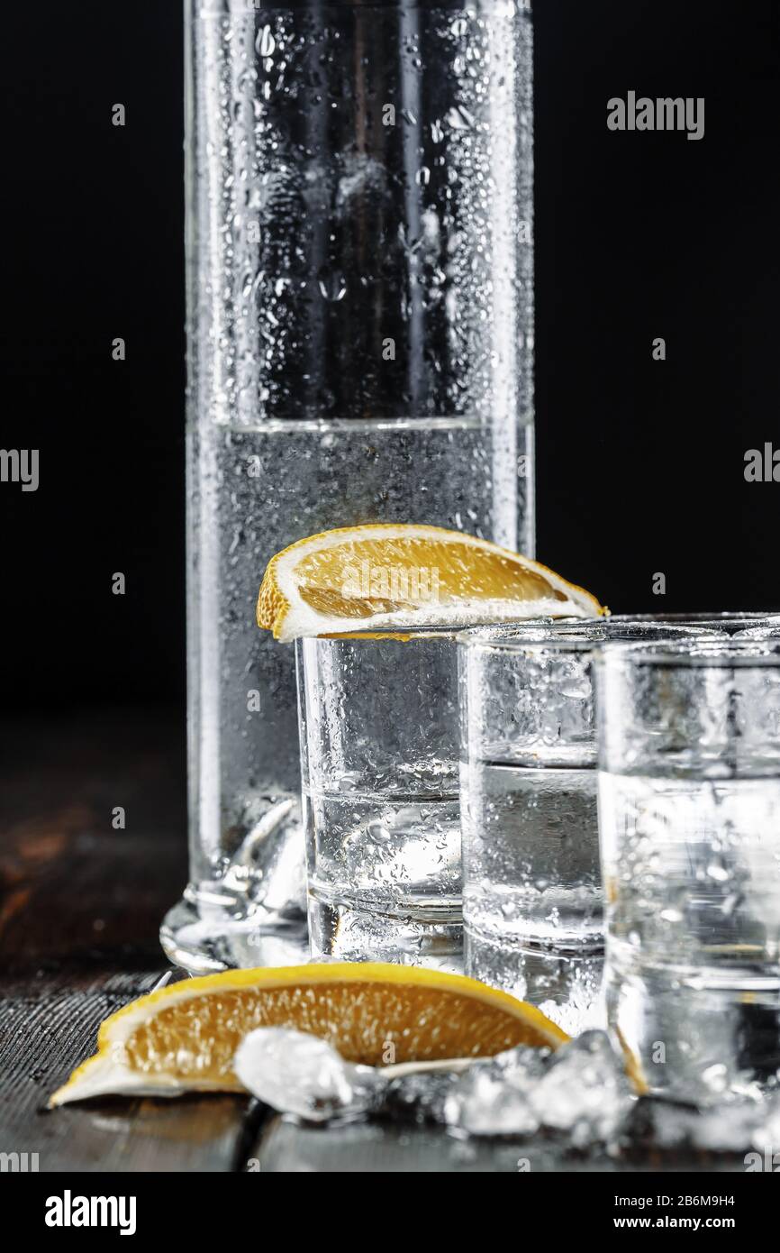 Vodka in shot glasses on rustic wood background Stock Photo - Alamy