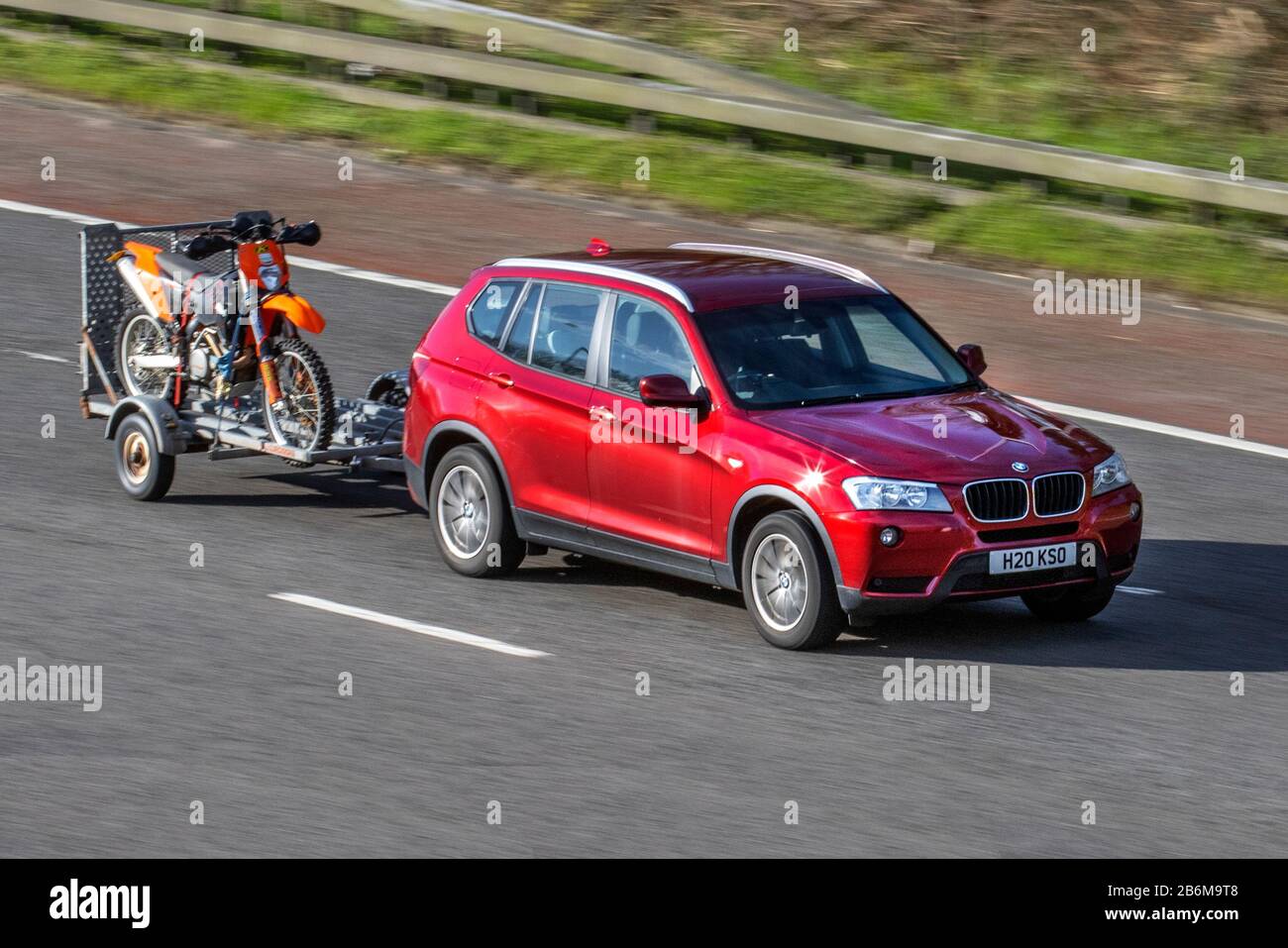 2103 red BMW X3 Xdrive20D SE Auto; UK vehicular traffic, transport, modern vehicles, saloon cars, moving vehicles, vehicle, roads, motors, motoring  on the M6 motorway highway Stock Photo