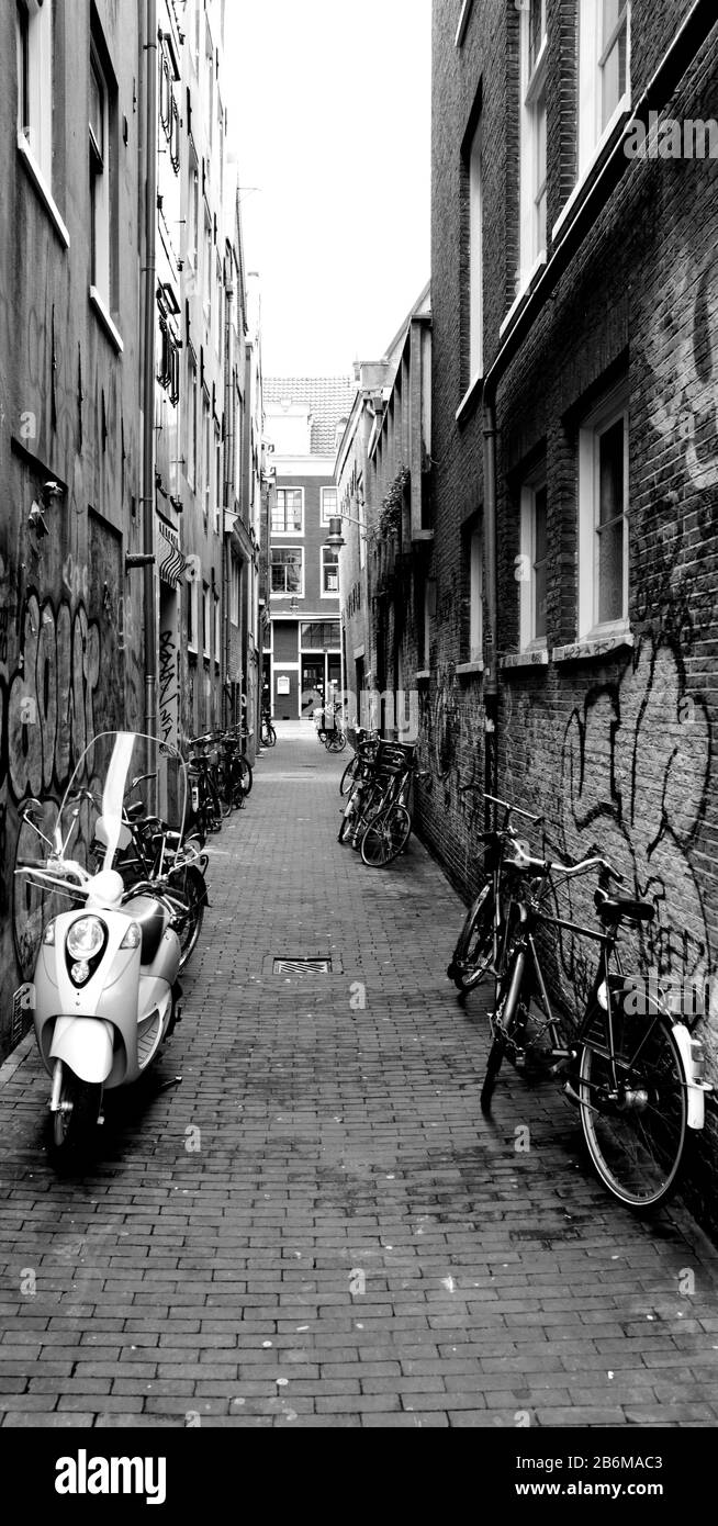 Scooters and bicycles parked in a street, Amsterdam, Netherlands Stock Photo