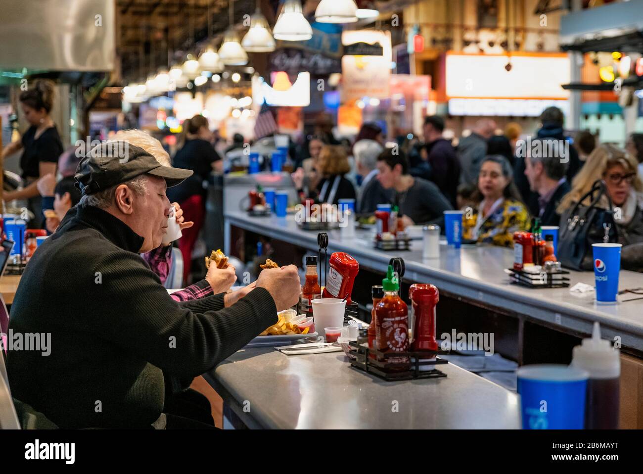 Diners eating lunch at the Reading Terminal Market in Philadelphia. Stock Photo