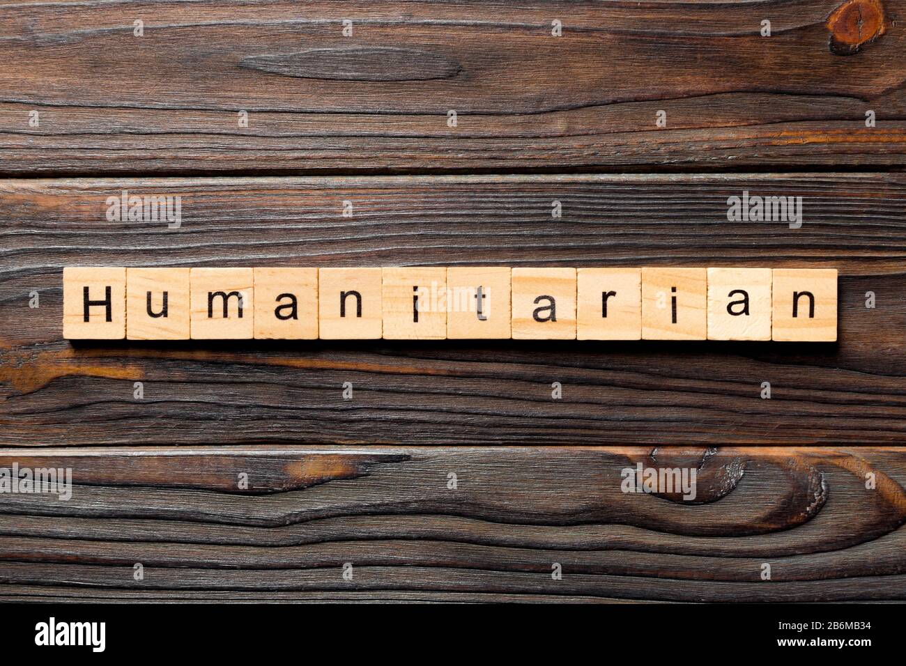 humanitarian word written on wood block. humanitarian text on table, concept. Stock Photo