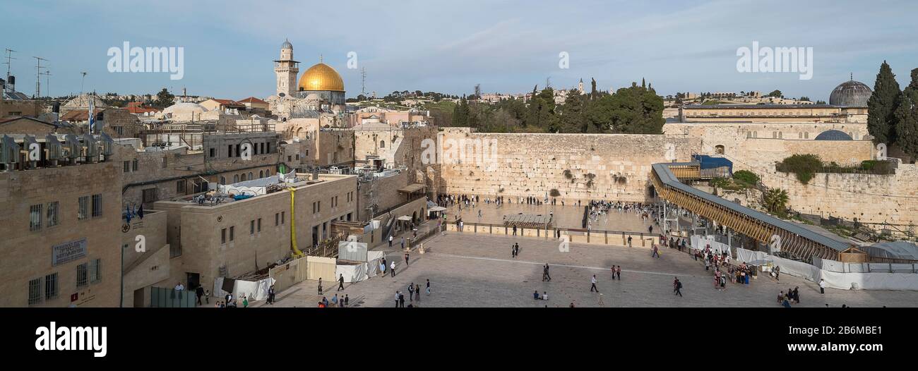 People praying at Western Wall with Dome of the Rock and Al-Aqsa Mosque in the background, Old City, Jerusalem, Israel Stock Photo
