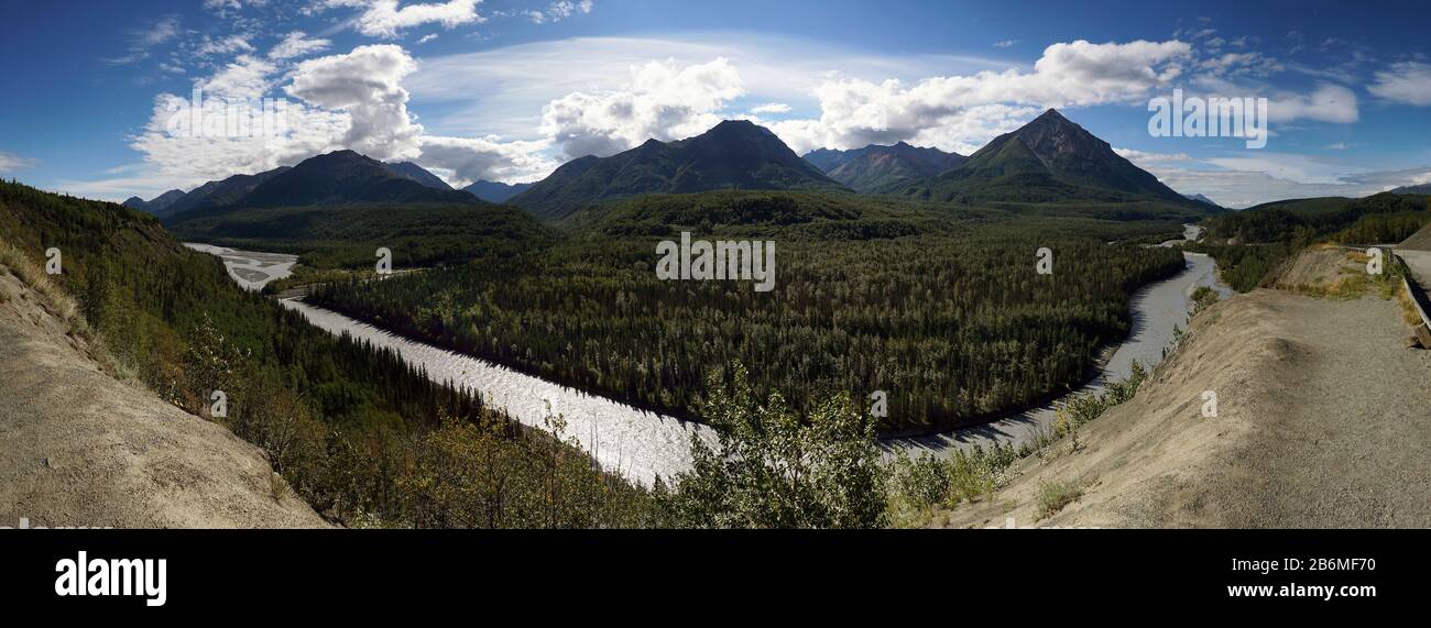 View of river, forest and mountains behind, Alaska, USA Stock Photo