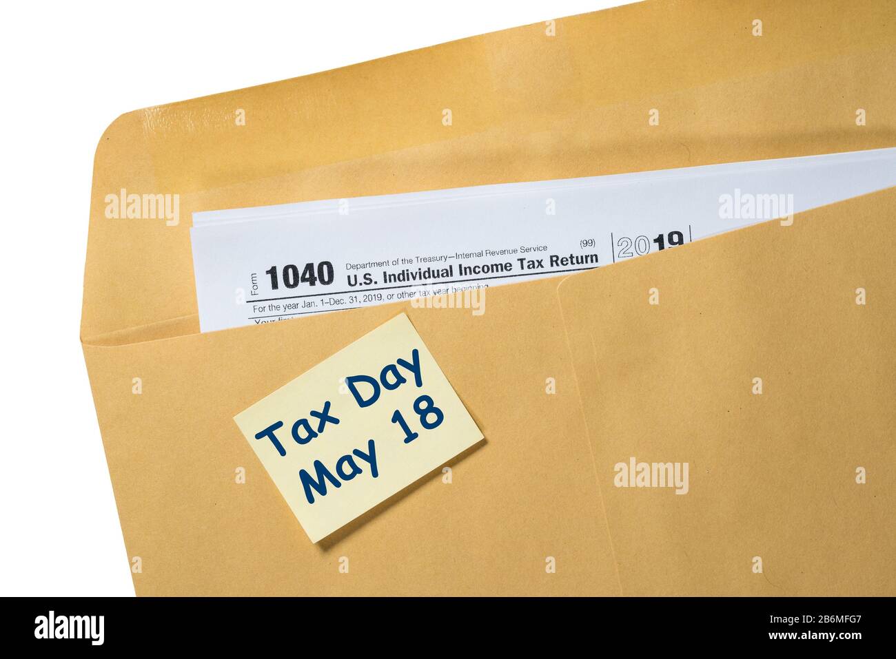 Printed Form 1040 for income tax return in brown envelope with reminder for May 18 tax day due to Covid-19 virus delay Stock Photo