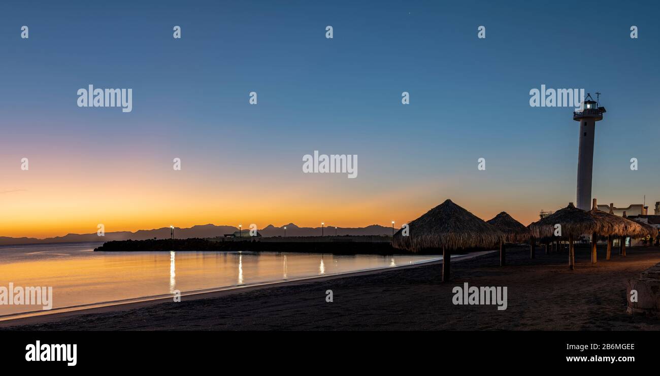 View of beach with lighthouse at dawn, Baja California Sur, Mexico Stock Photo