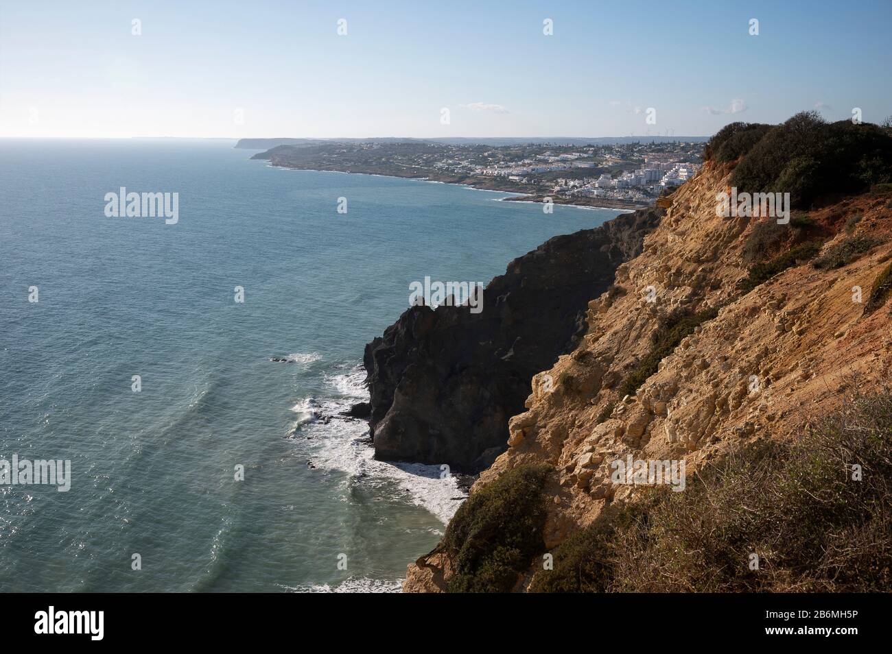 Black Rocks and cliffs on the coastline between Lagos and Luz, Portugal Stock Photo