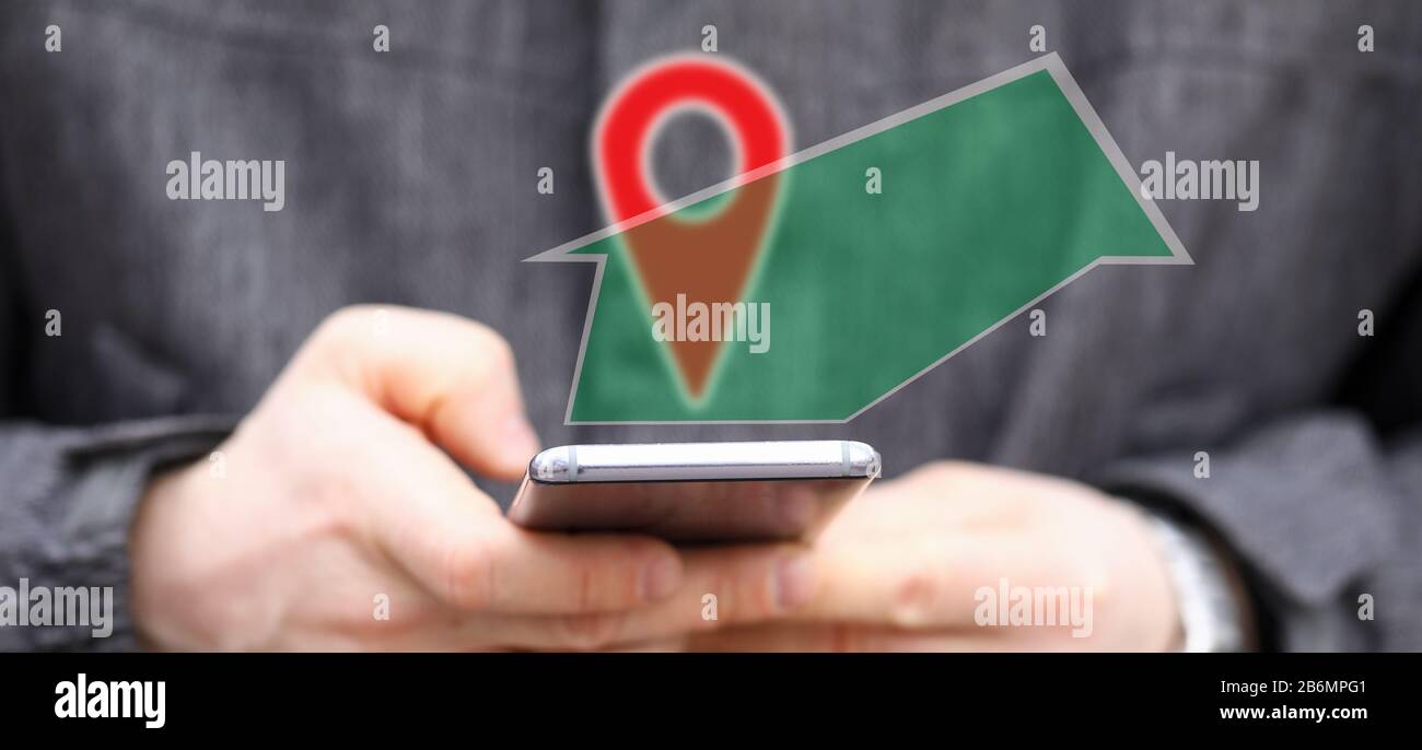 Man holding in hands smartphone while using navigation software Stock Photo