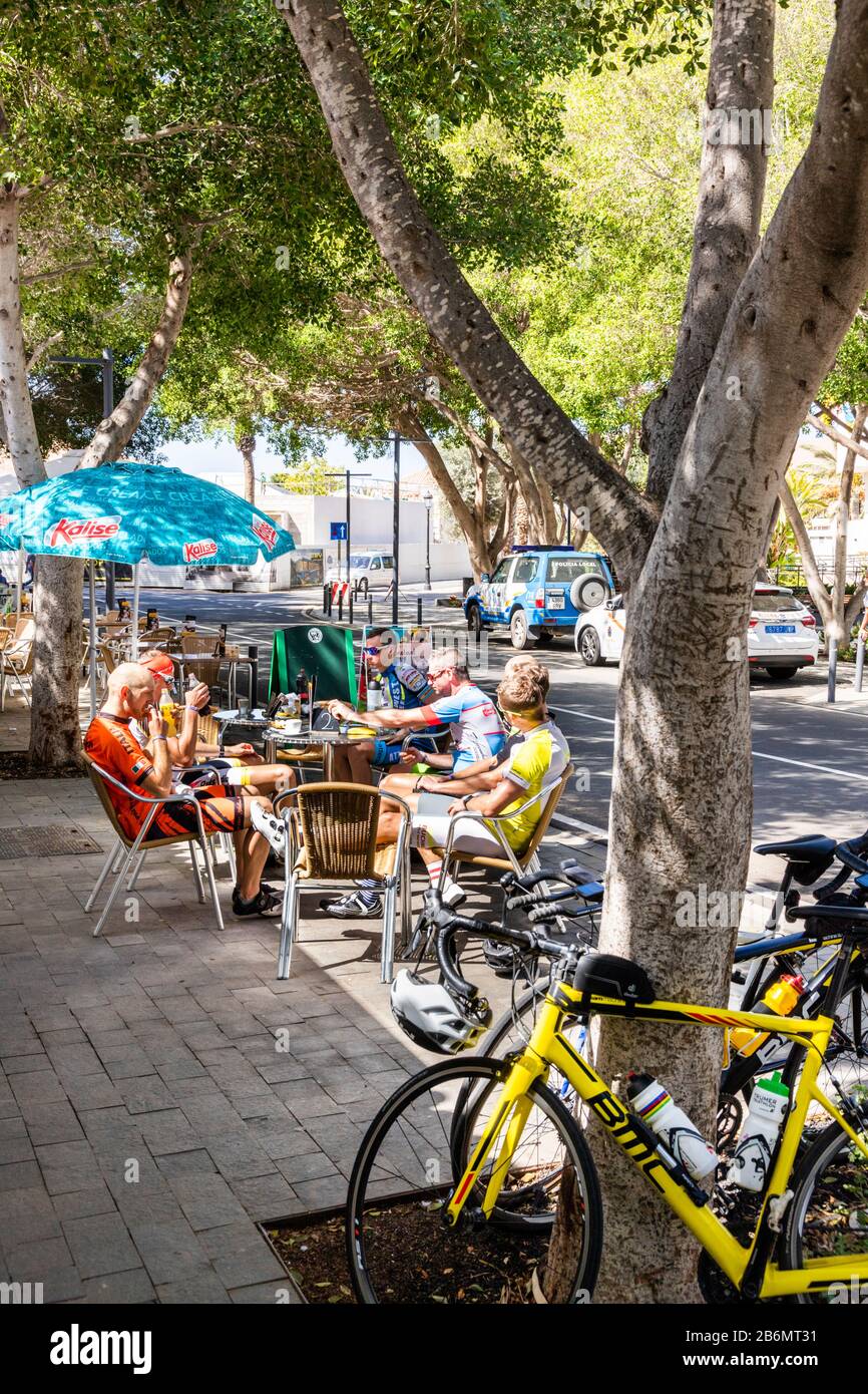 Cyclists relaxing at a roadside cafe in Pajara on the Canary Island of Fuerteventura Stock Photo