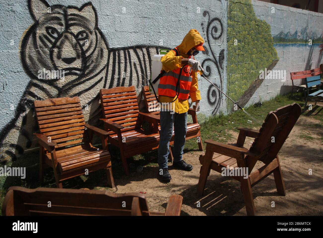 Rafah, Gaza. 11th Mar, 2020. Palestinian municipality workers wearing protective gear disinfect a park to help prevent the spread of the new coronavirus, in Rafah southern Gaza, Wednesday, March 11, 2020. The spokesman for the Ministry of Health in Gaza, Ashraf Al-Qedra, said, Gaza is devoid of Virus COVID-19, amidst fears due to new outbreaks in Europe, the Middle East and Asia. Photo by Ismael Mohamad/UPI Credit: UPI/Alamy Live News Stock Photo