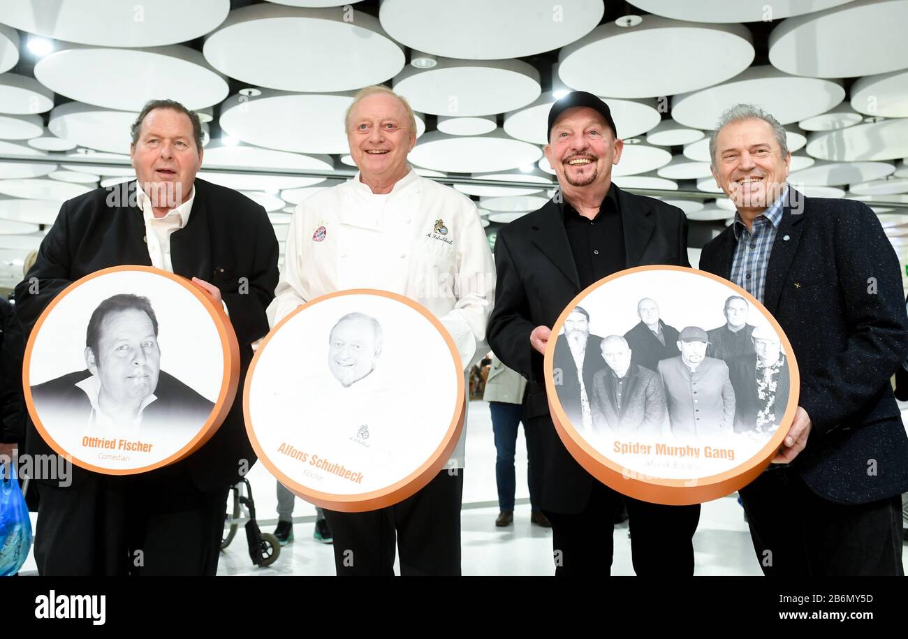 Munich, Germany. 11th Mar, 2020. Ottfried Fischer (l-r), actor, Alfons Schuhbeck, star cook, Barny Murphy and Günther Sigl from the band Spider Murphy Gang stand in the Stachus Passages and hold discs with pictures of them in front of them. In the Sky of Fame, on the ceiling circles of the Stachus Passagen, there are pictures of Munich personalities. Credit: Tobias Hase/dpa/Alamy Live News Stock Photo