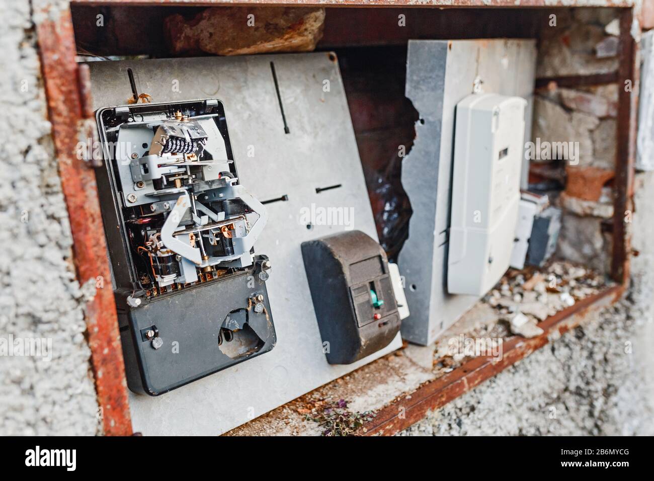 Vandals destroyed and broke the electric meter at the house Stock Photo