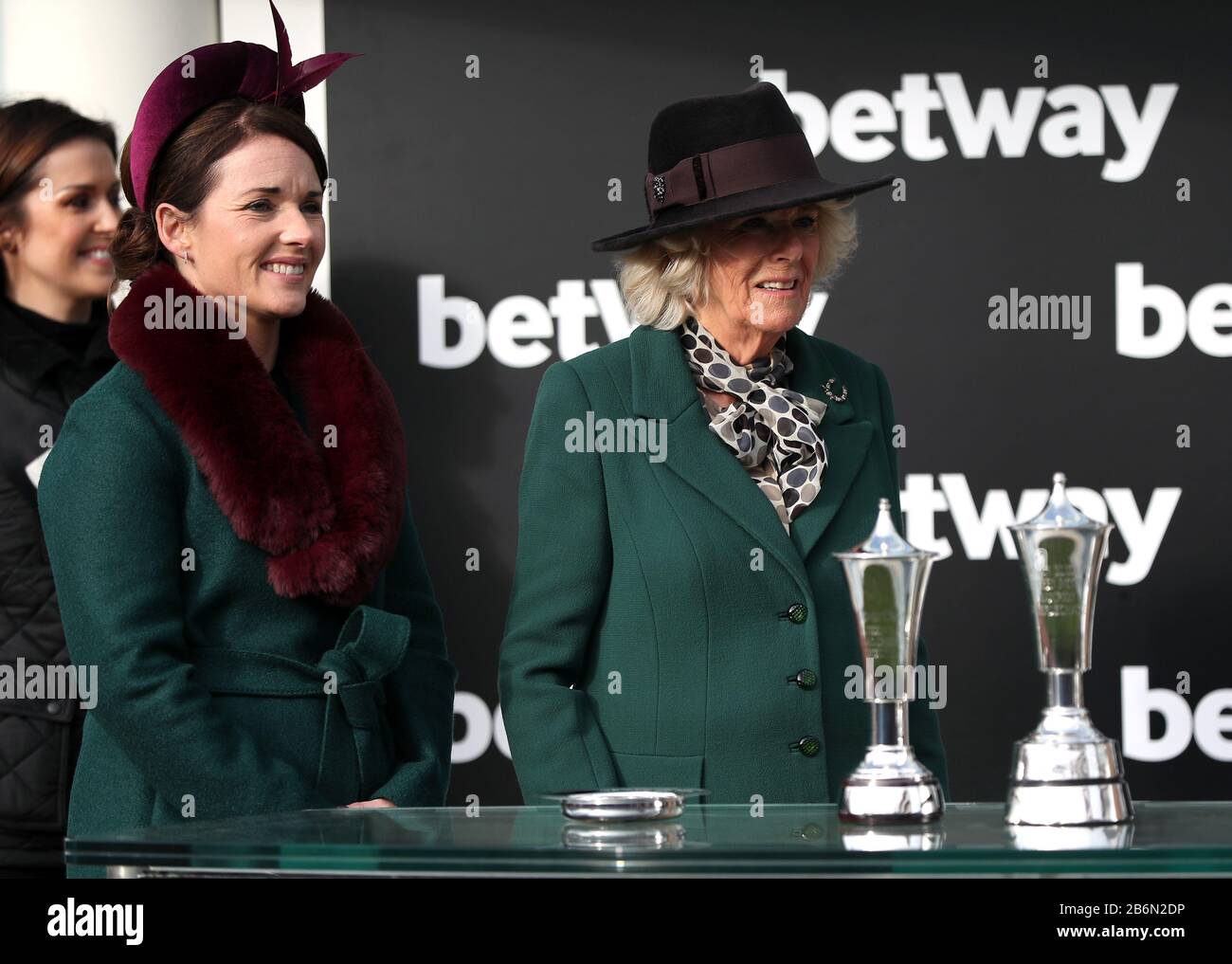 Katie Walsh (left) and Camila, Duchess of Cornwall (right) after the Betway Queen Mother Champion Chaseduring day two of the Cheltenham Festival at Cheltenham Racecourse. Stock Photo