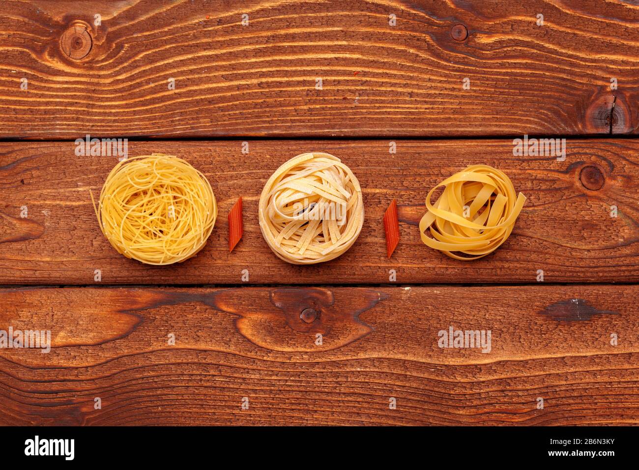 dried pasta on wooden background creative photo. Stock Photo