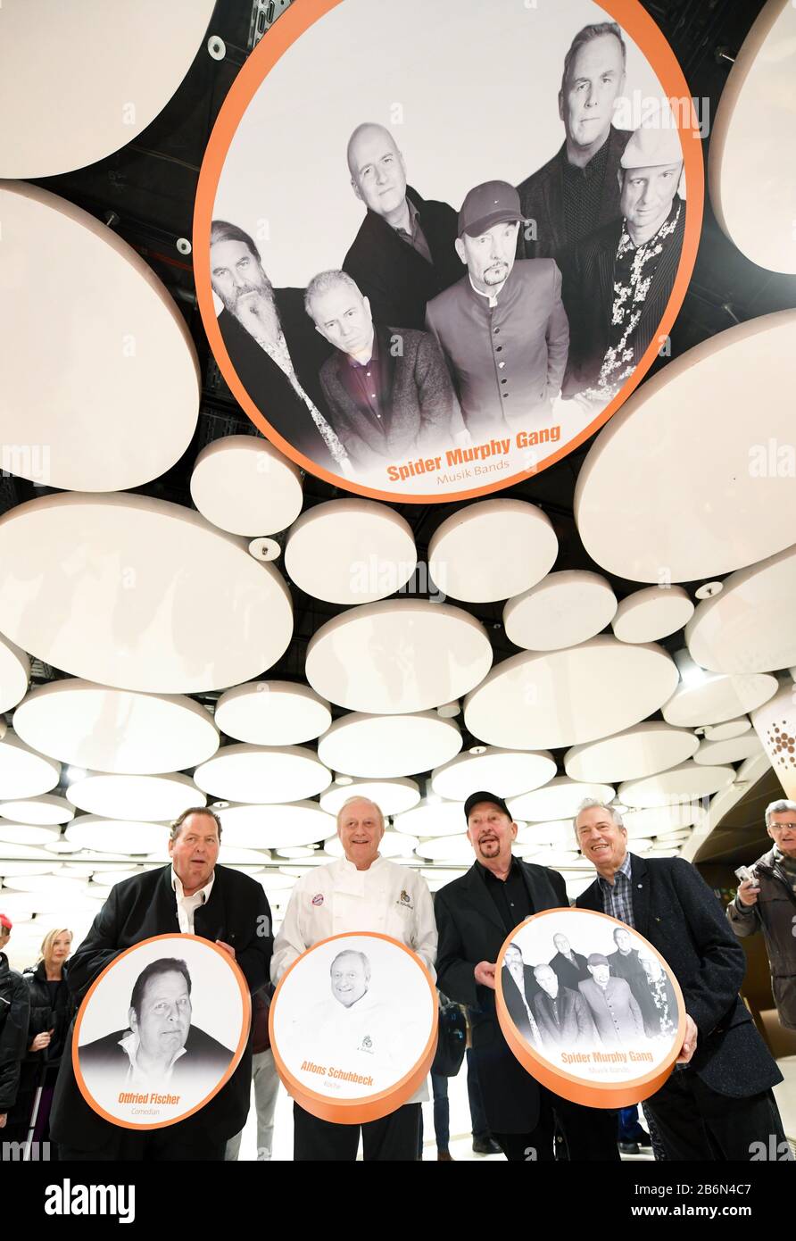 Munich, Germany. 11th Mar, 2020. Ottfried Fischer (l-r), actor, Alfons Schuhbeck, star chef, Barny Murphy and Günther Sigl, musician of the band Spider Murphy Gang, are standing in the Stachus Passages under a ceiling circle in the Sky of Fame with a photo of the band Spider Murphy Gang. In the Sky of Fame, at the ceiling circles of the Stachus Passages, there are pictures of Munich personalities. Fischer, Schubeck, Murphy and Sigl have revealed their pictures. Credit: Tobias Hase/dpa/Alamy Live News Stock Photo