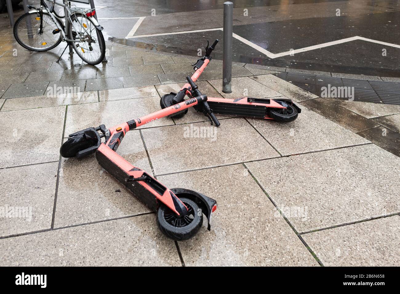 Voi e scooters dumped on Frankfurt street creating a trip hazard, Germany Stock Photo