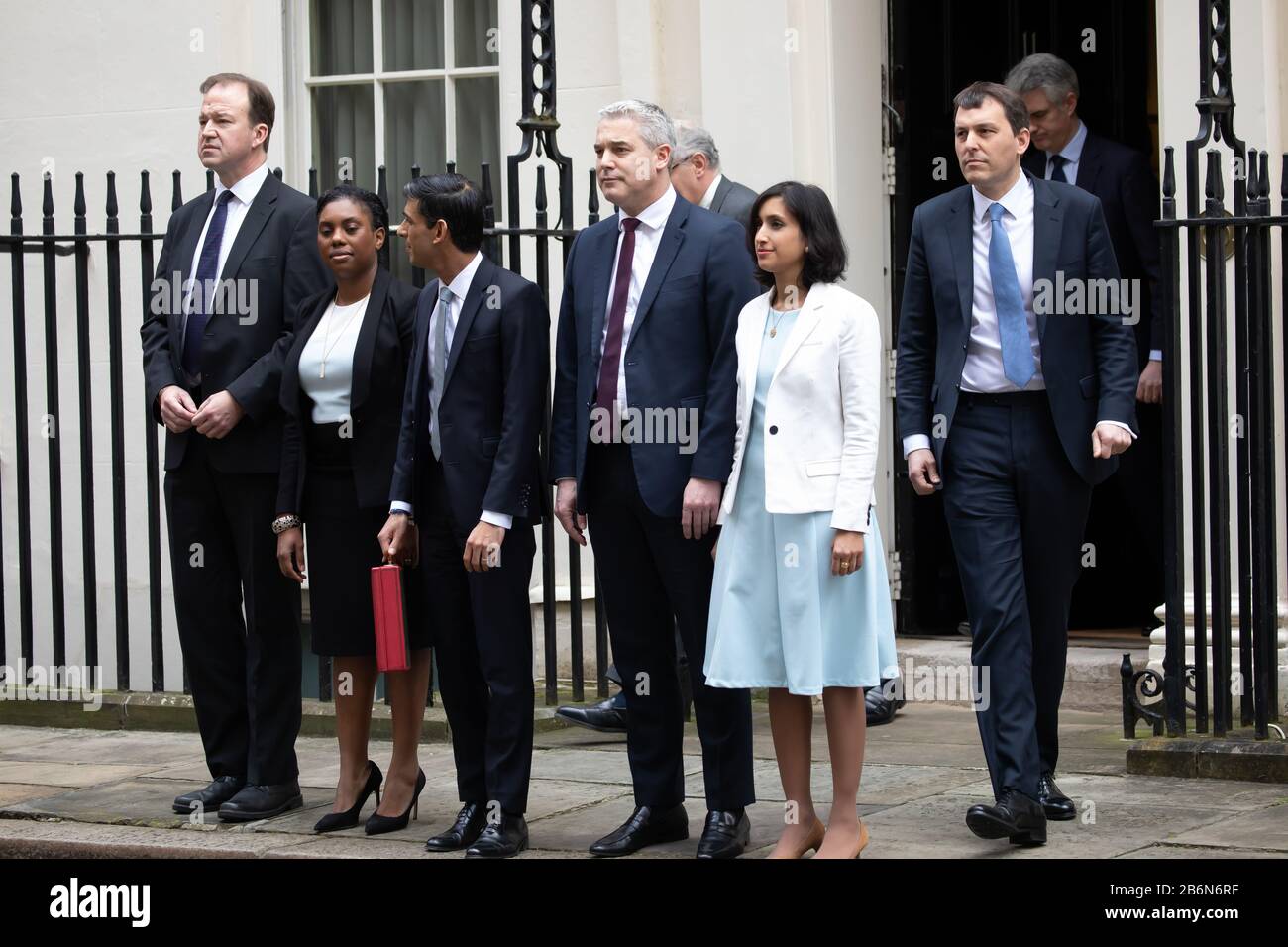 Members of the Treasury pose for photos on Budget Day in Downing Street, London, UK Stock Photo