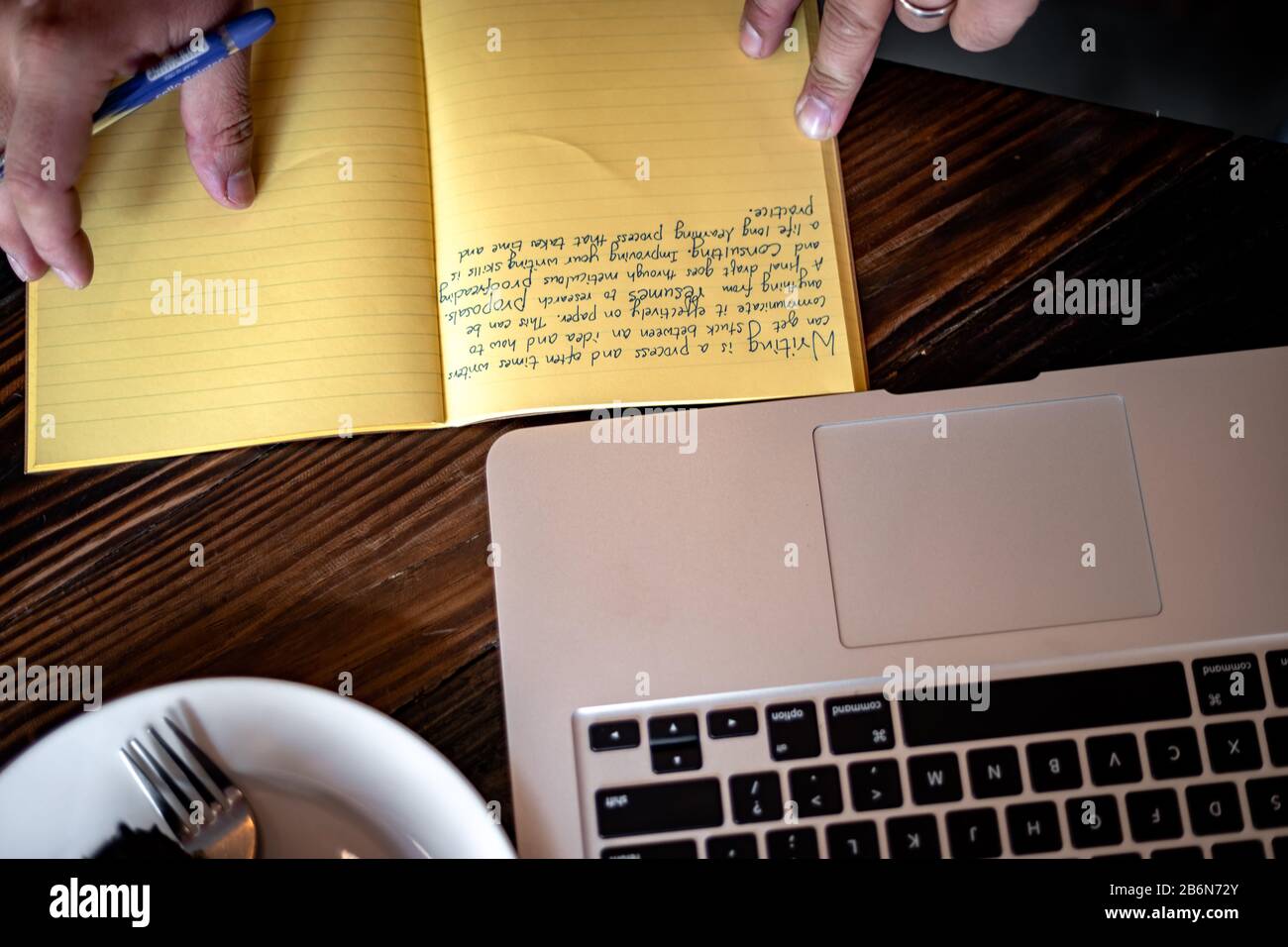 Taking Note Concept. Hand of a young businessman taking notes with a fountain pen on a notecopy