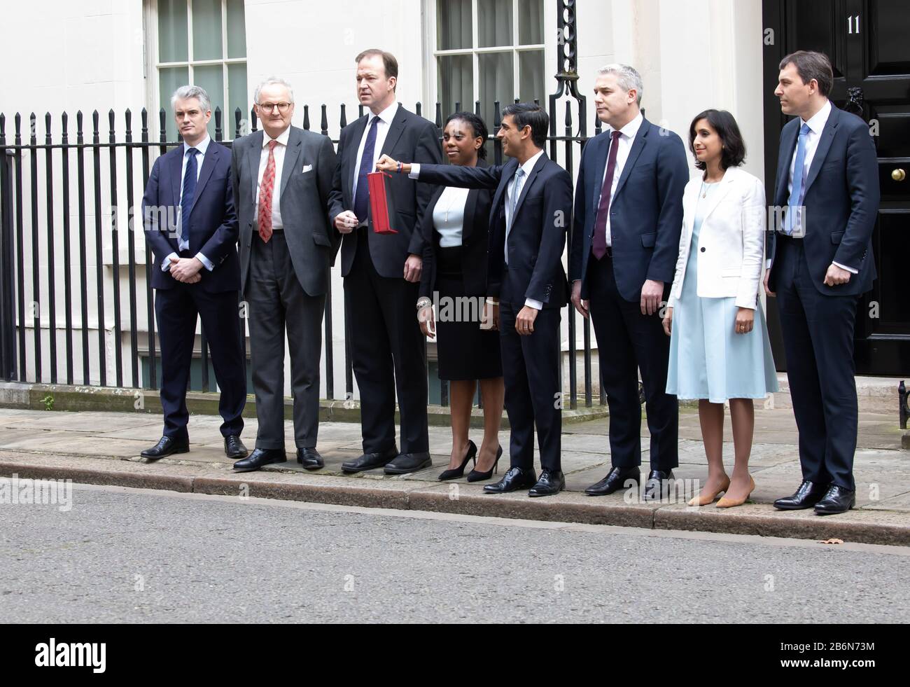 Members of the Treasury pose for photos on Budget Day in Downing Street, London, UK Stock Photo