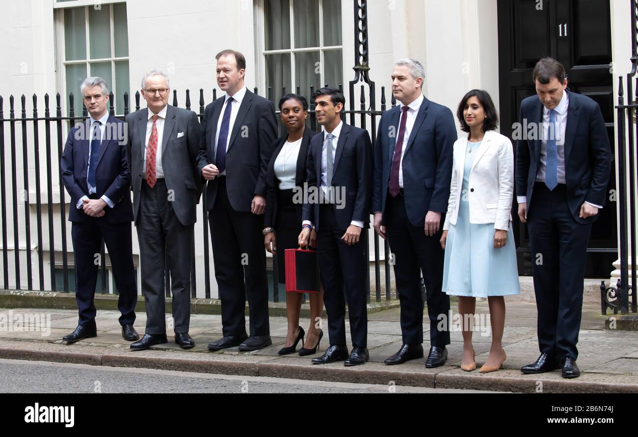 Members of the Treasury pose for photos on Budget Day in Downing Street, London, UK Stock Photo