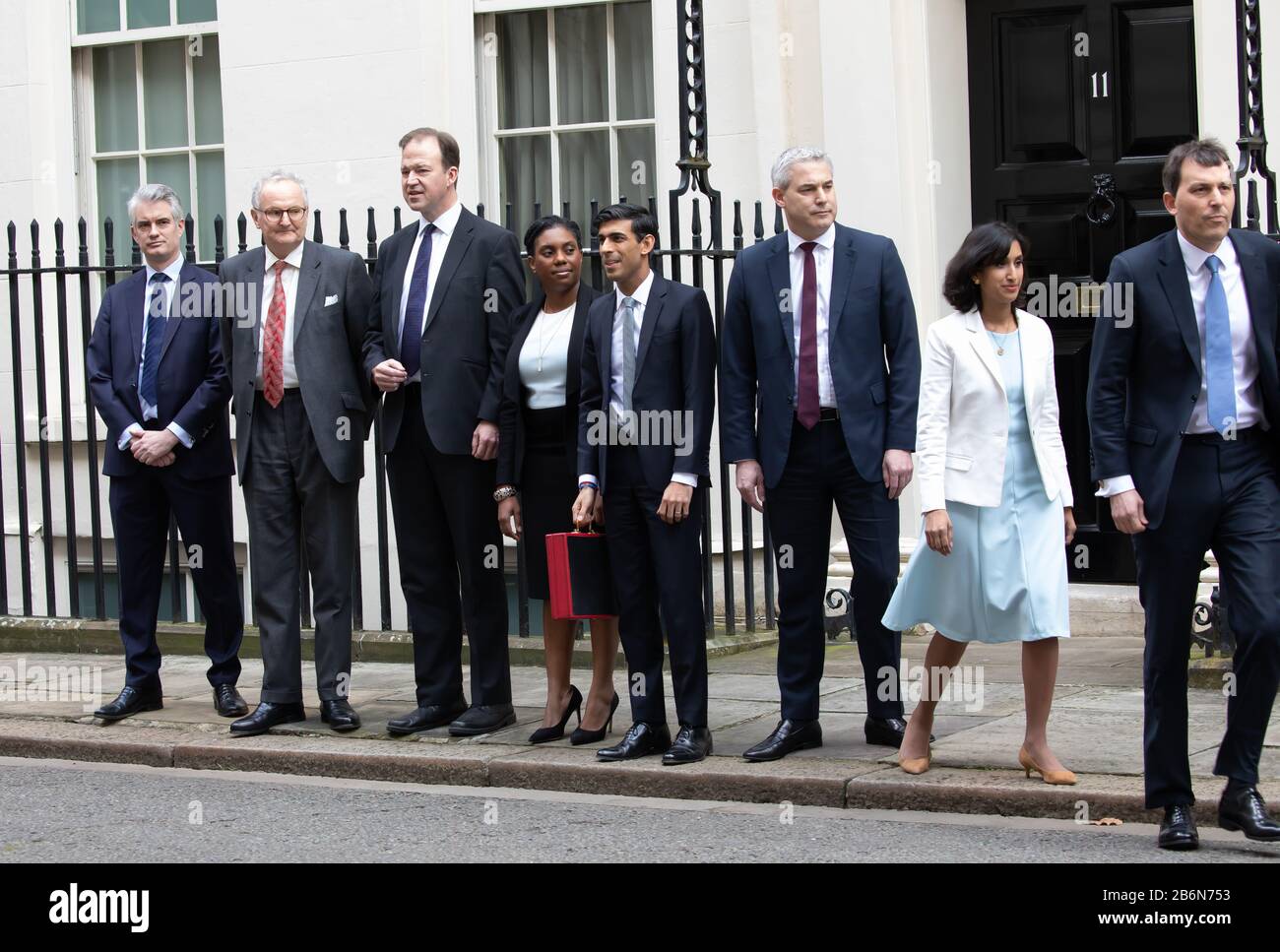Members of the Treasury pose for photos on Budget Day in Downing Street, London, UK Stock Photo