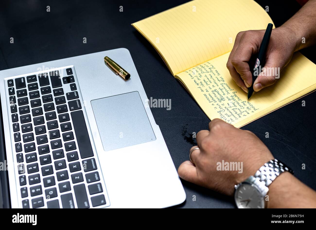 Taking Note Concept. Hand of a young businessman taking notes with a ...