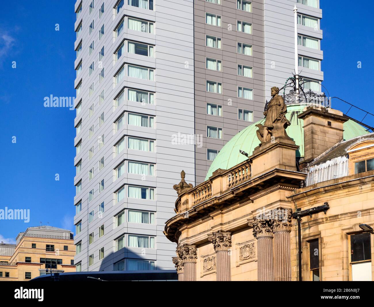 Domed roof of The Observatory former bank now a bar against the modern Park Plaza tower block Leeds West Yorkshire England Stock Photo