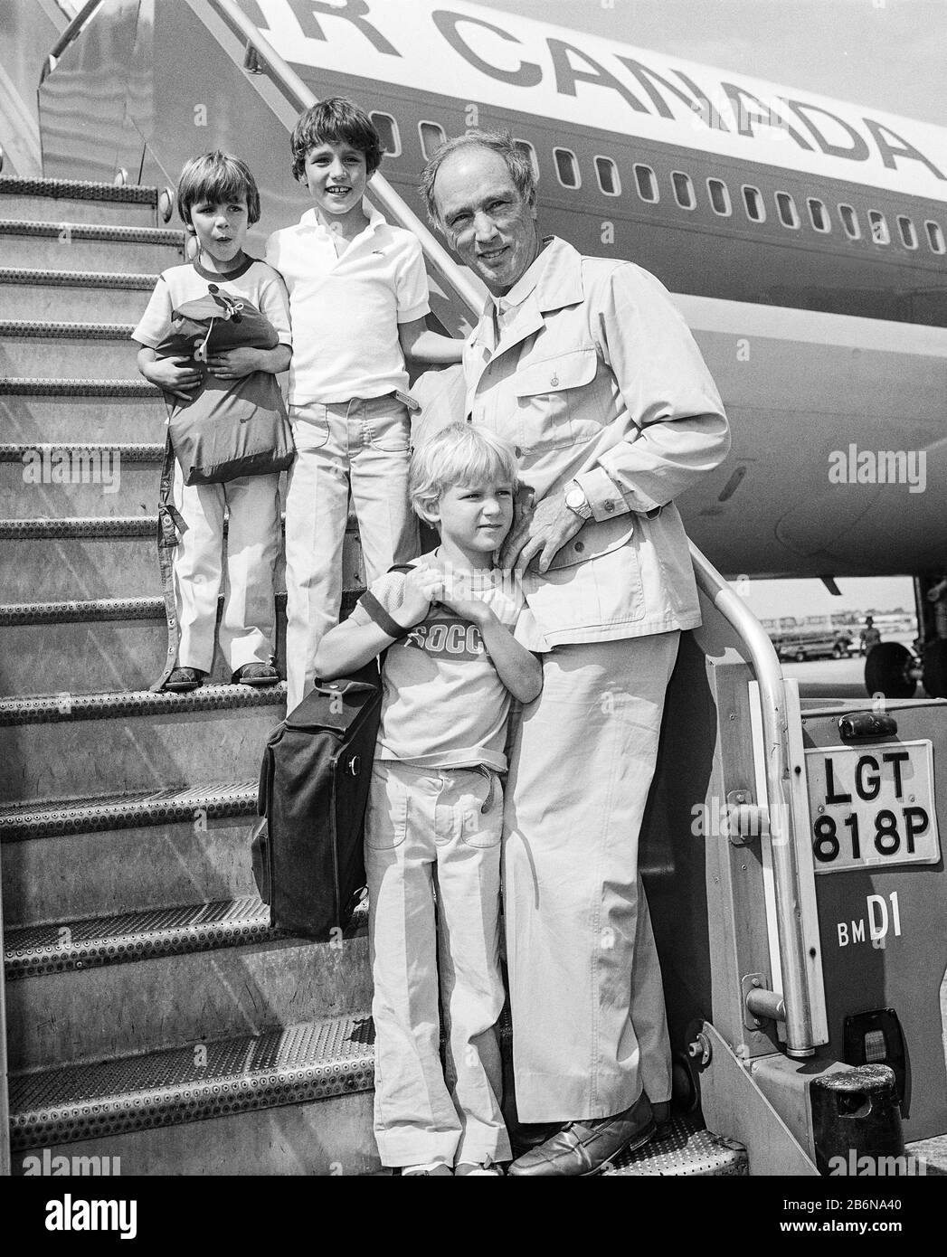 Canadian Prime Minister Pierre Trudeau leaving London's Heathrow Airport with his three sons Justin, Alexandre and Michel in August 1981. Stock Photo