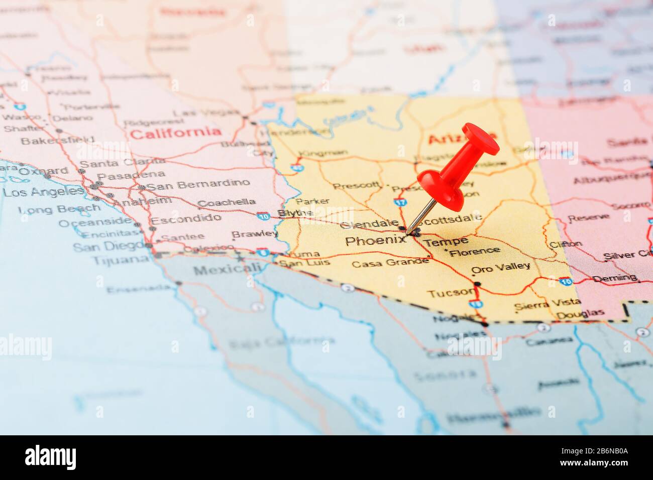 Red clerical needle on a map of the USA, Arizona and the capital Phoenix. Close up map of