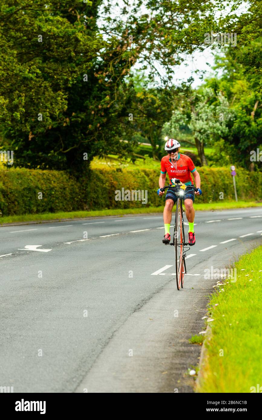 Richard Thoday on the A6 in Lancashire on the way to breaking the Penny Farthing Land’s End to John O’Groats record Stock Photo
