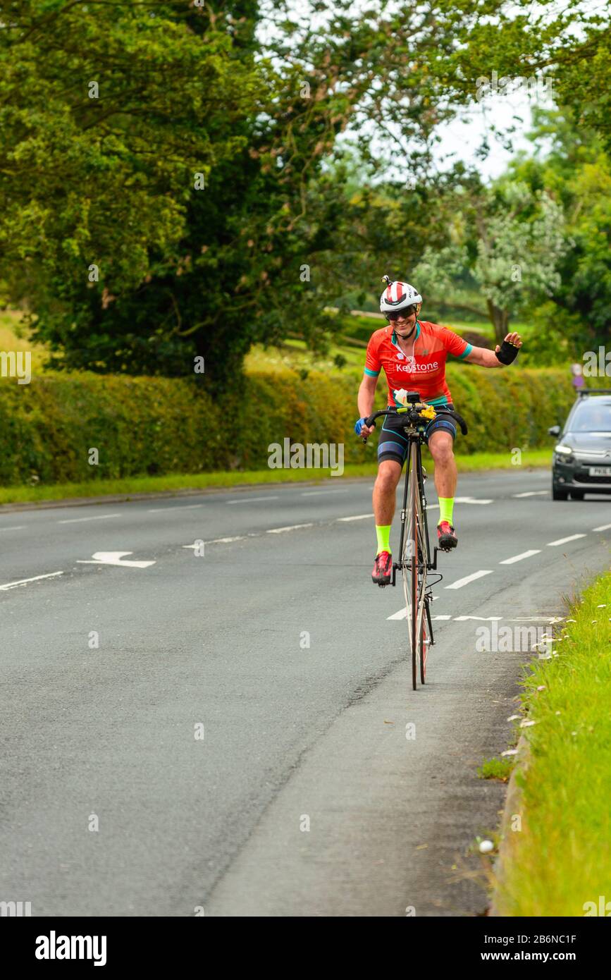 Richard Thoday on the A6 in Lancashire on the way to breaking the Penny Farthing Land’s End to John O’Groats record Stock Photo