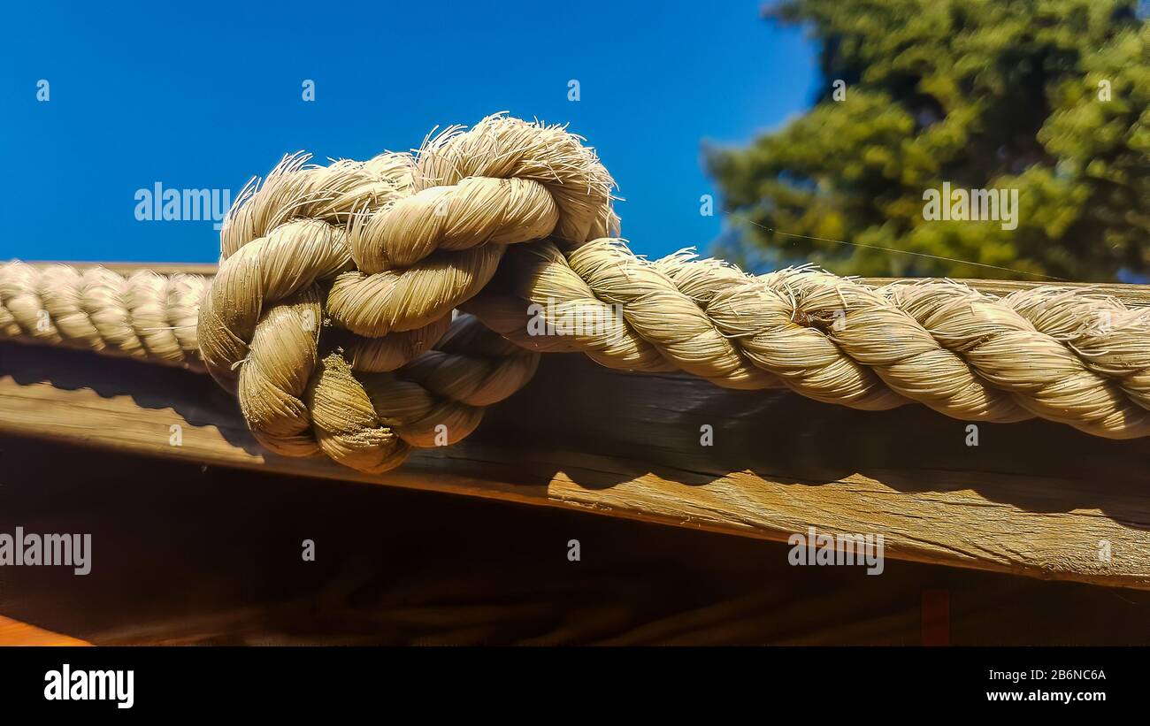 thick old rope with a knot Stock Photo