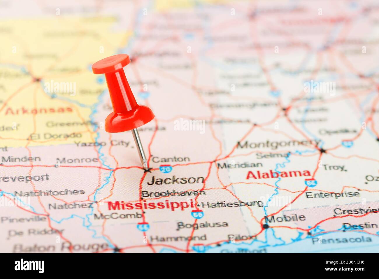 Red clerical needle on a map of USA, South Mississippi and the capital
