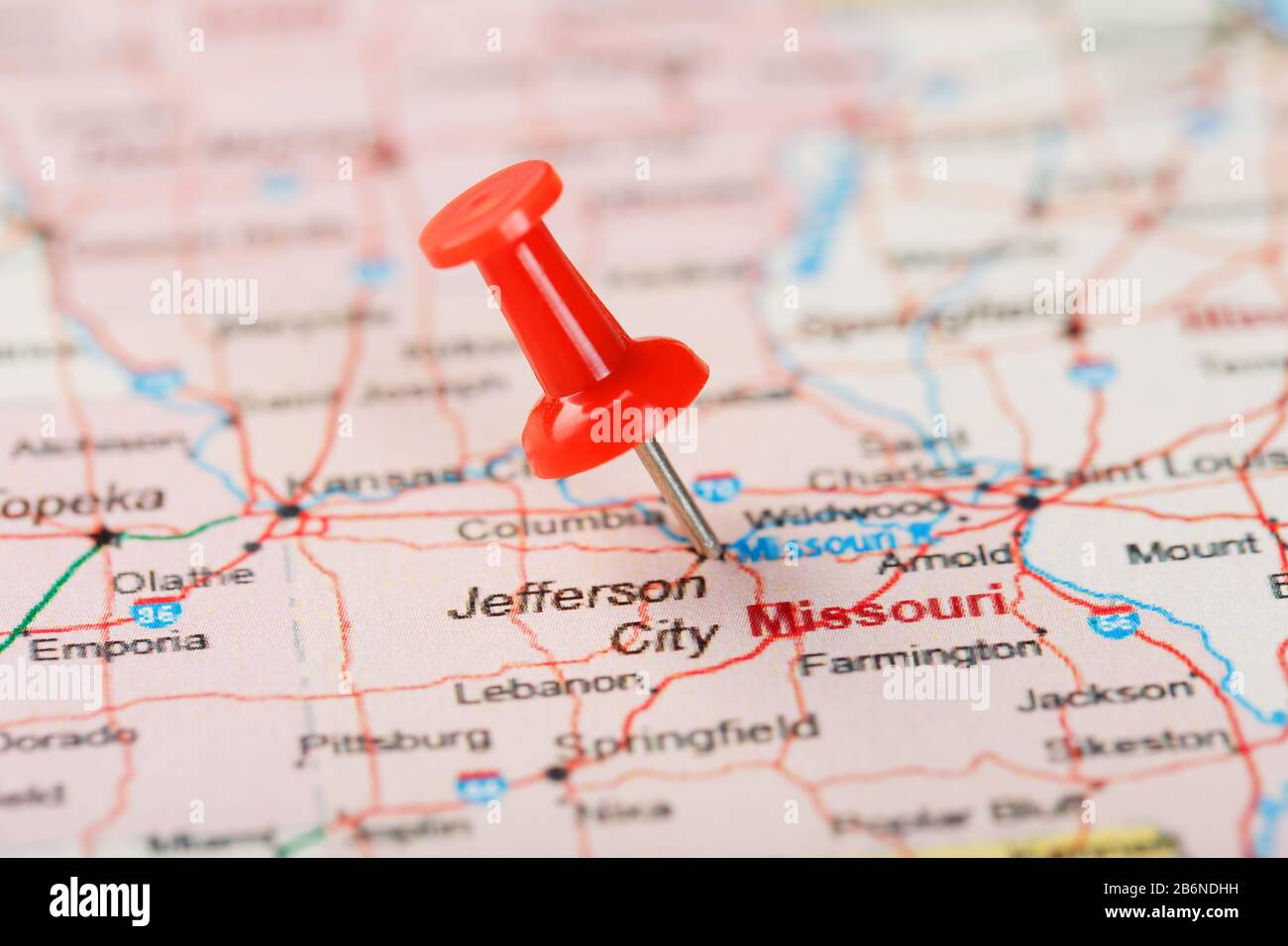 Red clerical needle on a map of USA, Missouri and the capital Jefferson