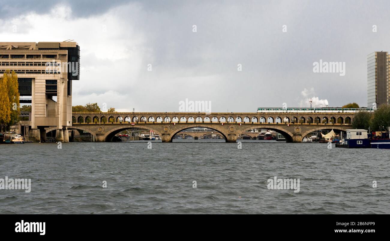 A view to Pont de Bercy bridge with a passenger train crossing Seine river, Paris, France Stock Photo