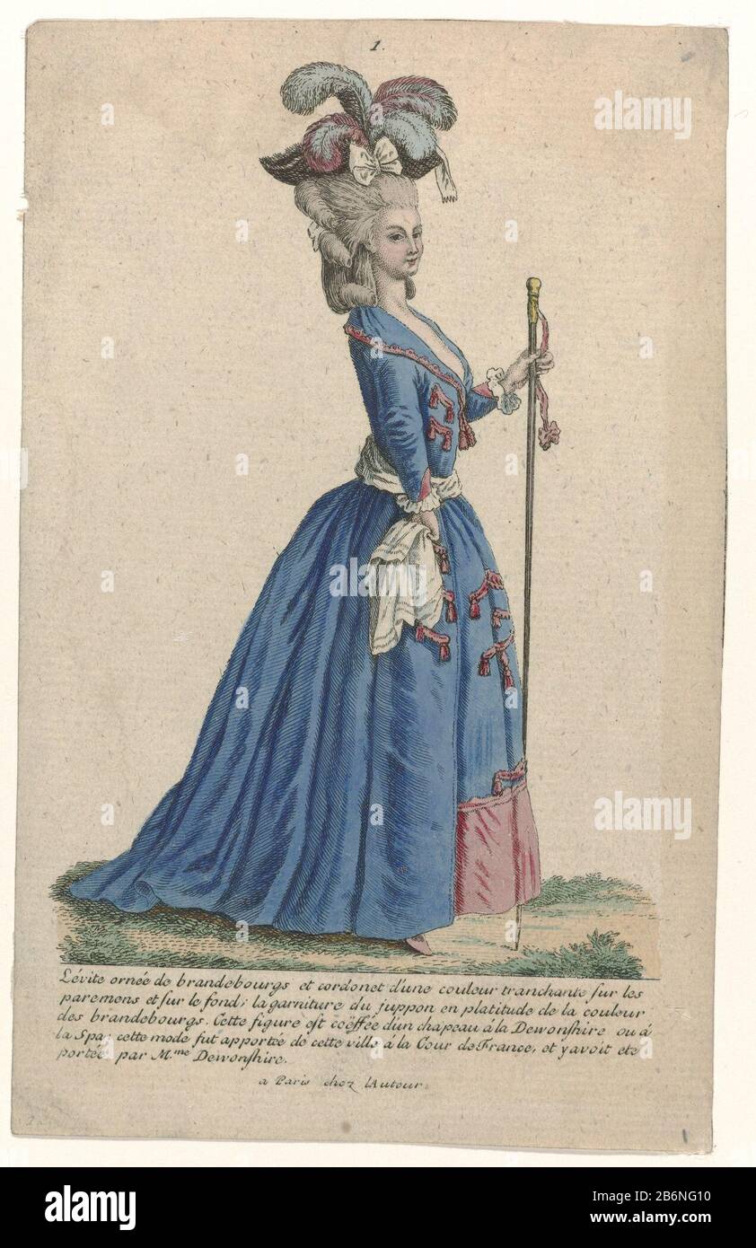 Standing woman wearing a Levite train, decorated with brandebourgs and  purl. The skirt is trimmed with a wide band is like purl and brandebourgs  in a contrasting color. Accessories: a hat with