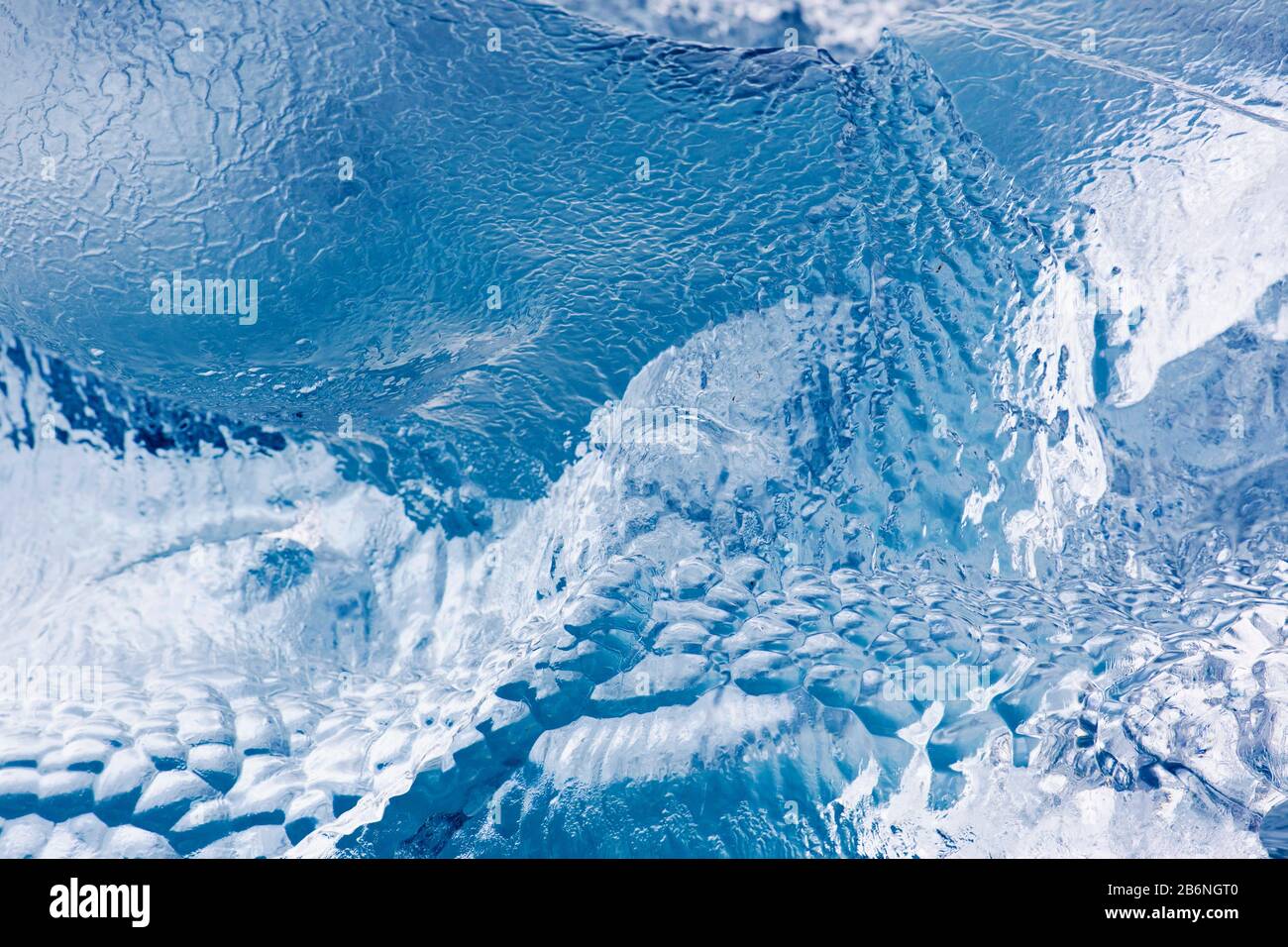 Abstract pattern in melting ice floe / iceberg showing texture due to meltwater / melt water Stock Photo