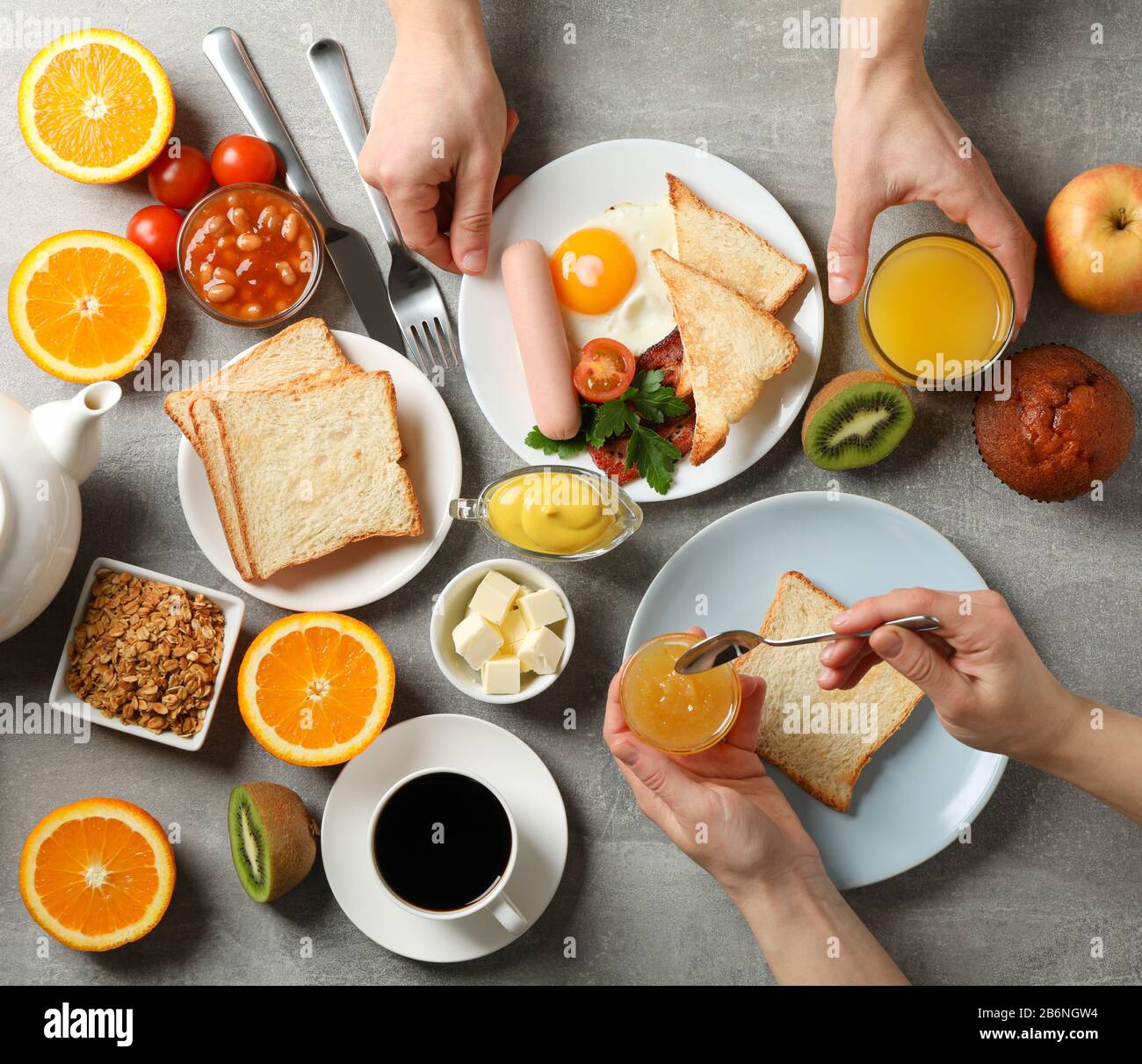 Delicious breakfast or lunch background. Grey table. People eat Stock ...