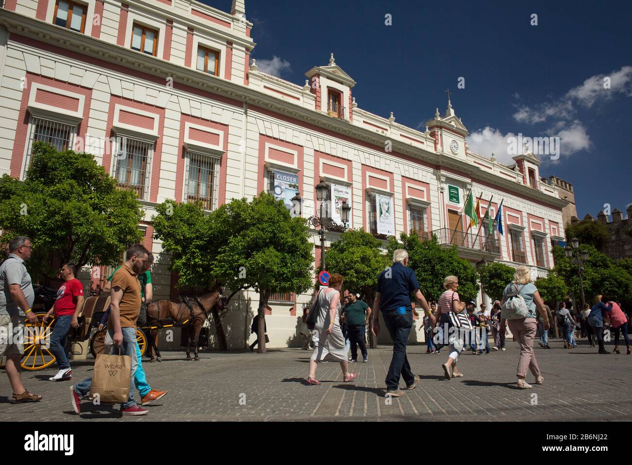 Passersby close to Provincia’s House at Triunfo Square, Seville, Spain Stock Photo