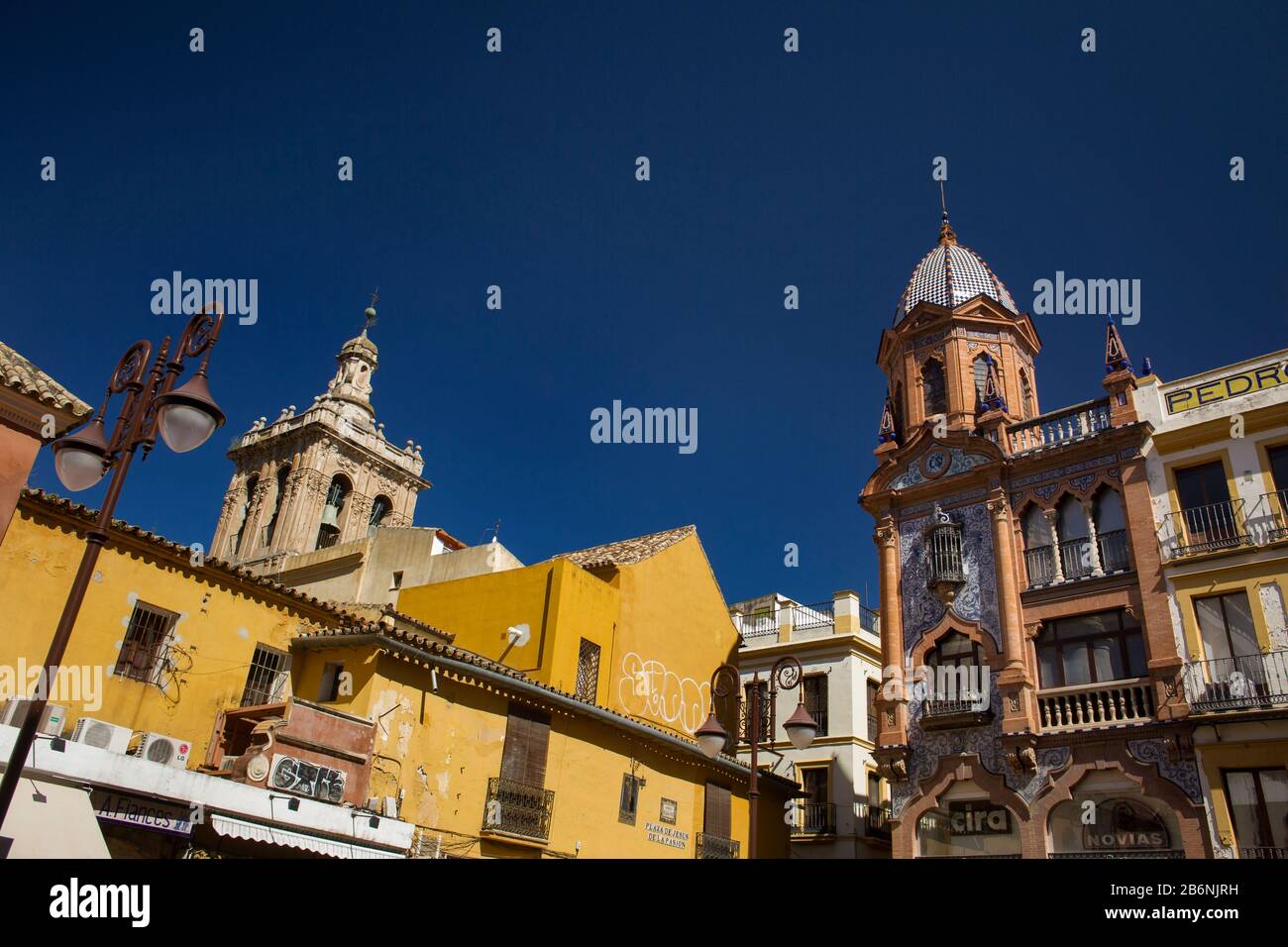 Colorful low-angle shot of the roofs of the historic buildings of Jesus de la Pasion Square, Seville, Spain Stock Photo