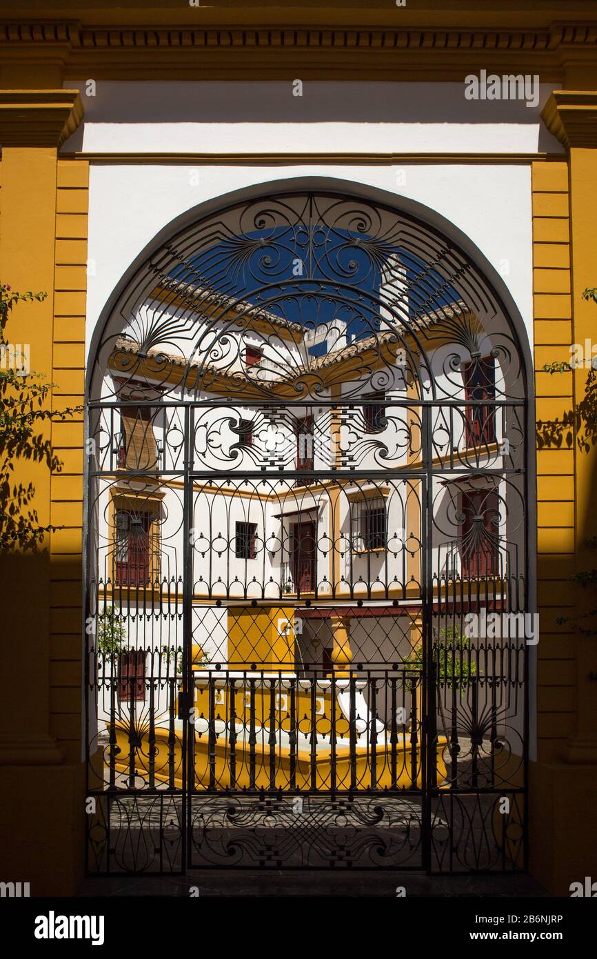 Colorful vertical shot of one of the wrought-iron gates of the premises of La Maestranza bullring building, Seville, Spain Stock Photo