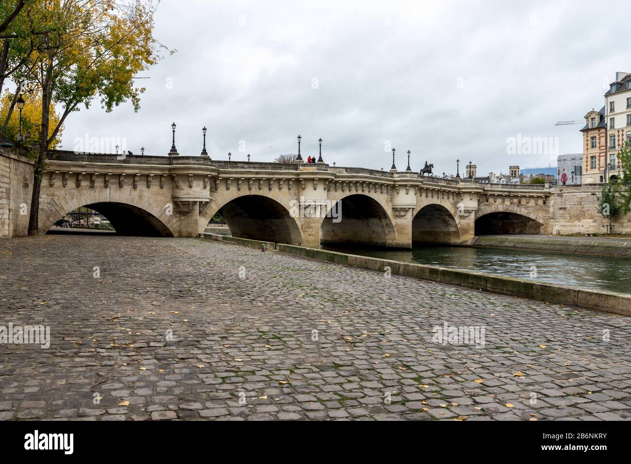 Stone paved promenade walk along Seine river near bridge Neuf in central Paris, France Stock Photo