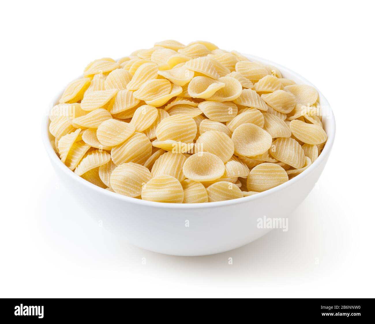 Uncooked orecchiette pasta in white bowl isolated on white background with clipping path Stock Photo