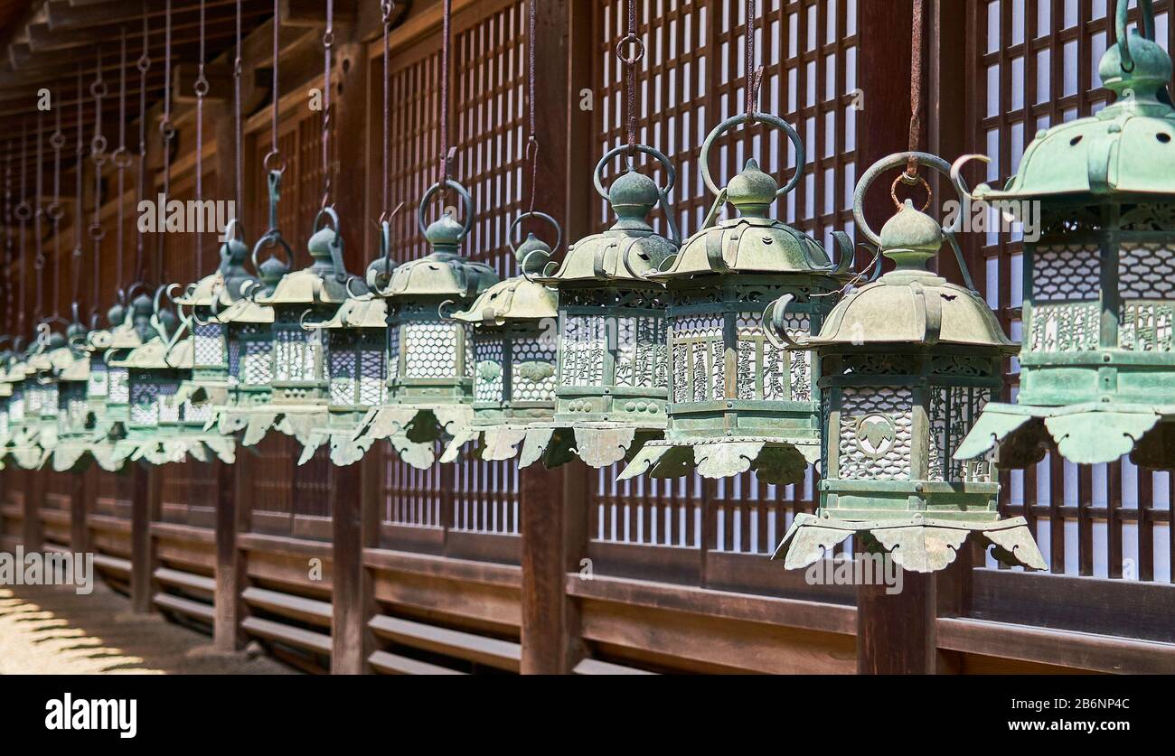 A row of bronze japanese lanterns in Kasuga-Taisha shrine in Nara. Stock Photo