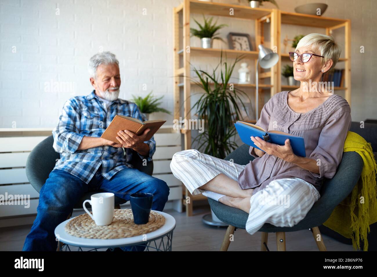 Happy senior couple relaxing at home together Stock Photo - Alamy