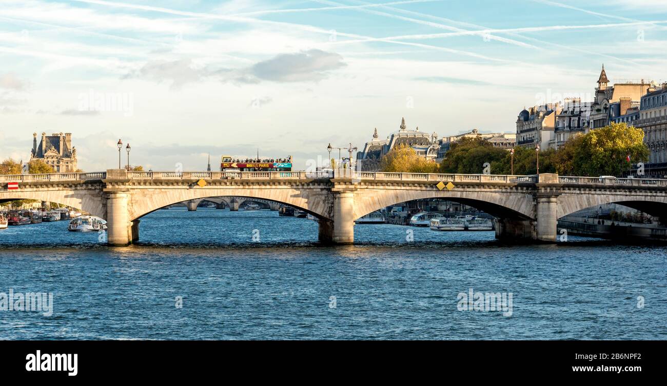 A Pont De la Concorde bridge across Seine river with a double decker tourist sightseeing bus, Paris, France Stock Photo