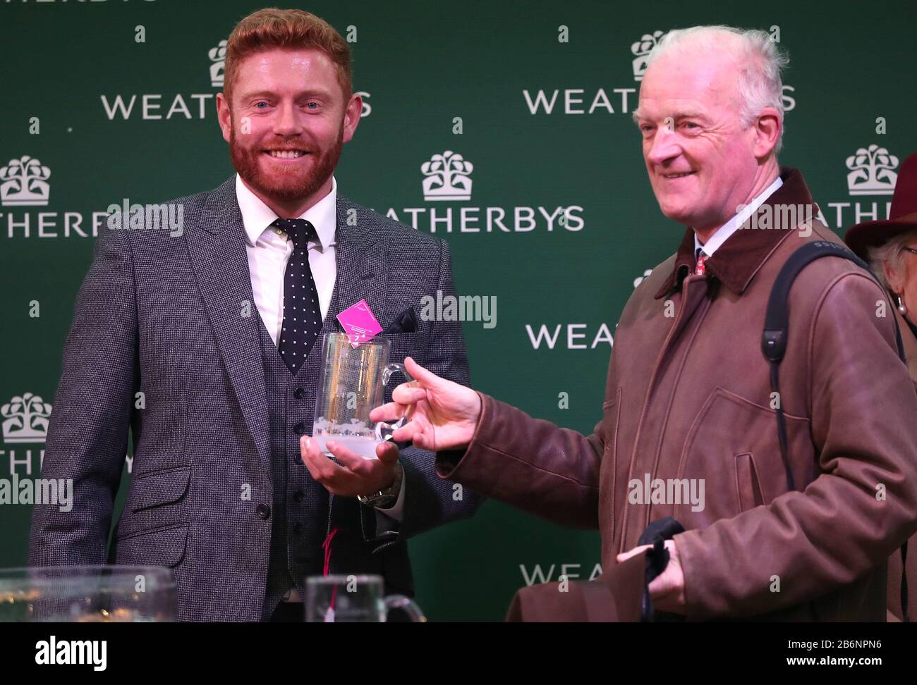 Jonny Bairstow (left) with trainer Willie Mullins during day two of the Cheltenham Festival at Cheltenham Racecourse. Stock Photo