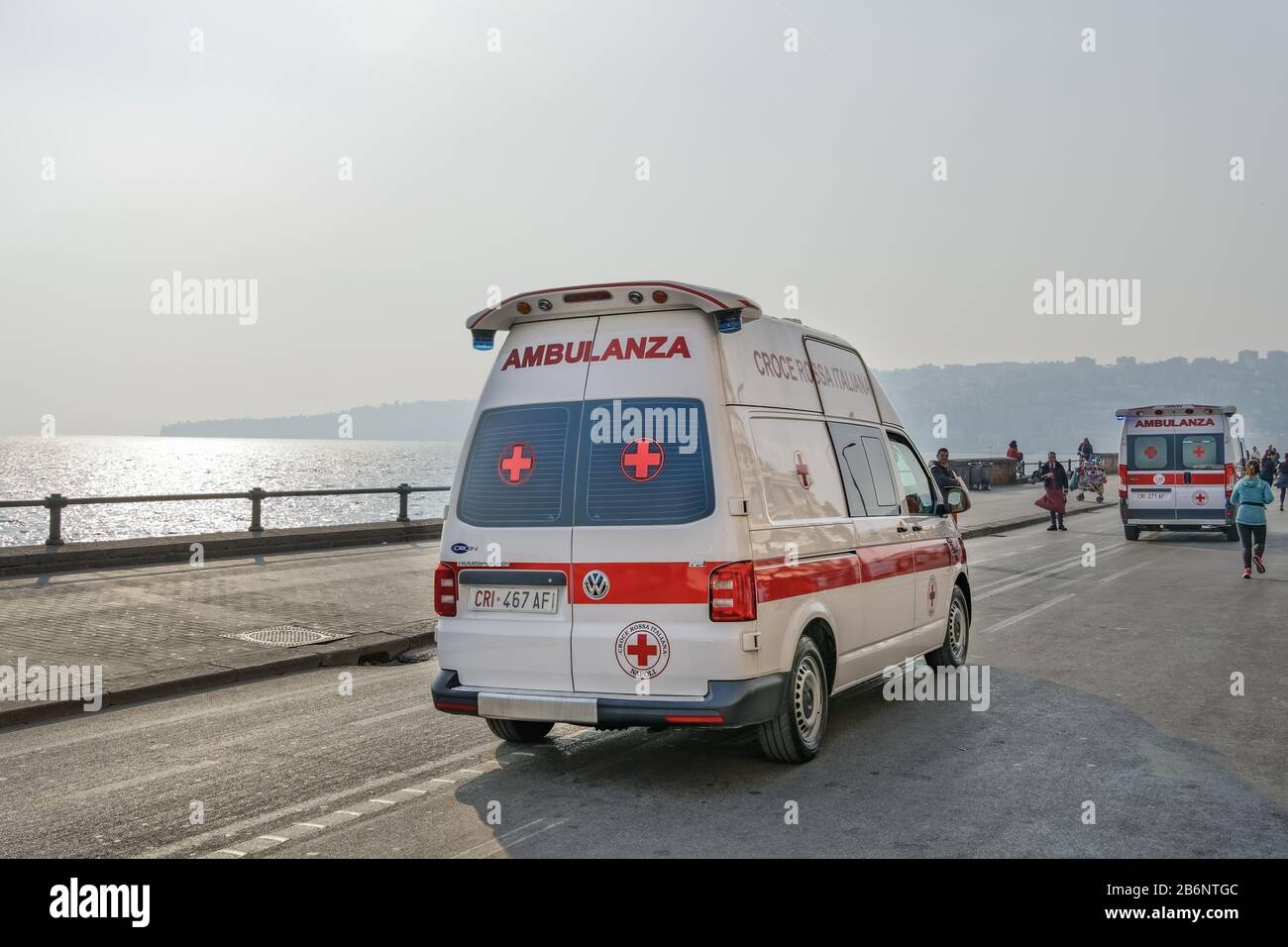 Italian Red Cross Ambulance speeding on street during medical emergency. Croce Rossa Italiana cars running through the streets of Naples waterfront. Stock Photo