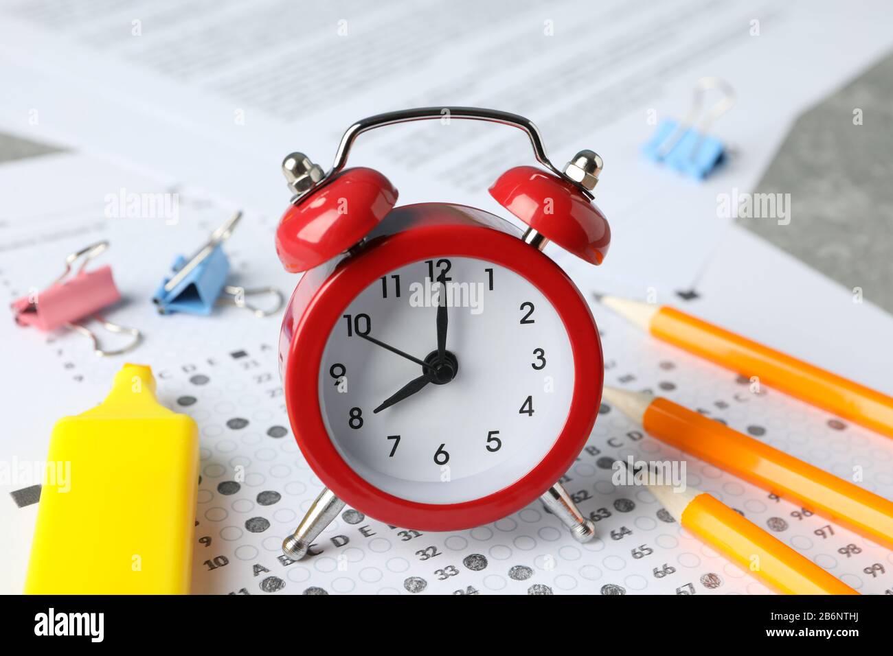 Test score sheet, alarm clock and stationery, close up Stock Photo Alamy
