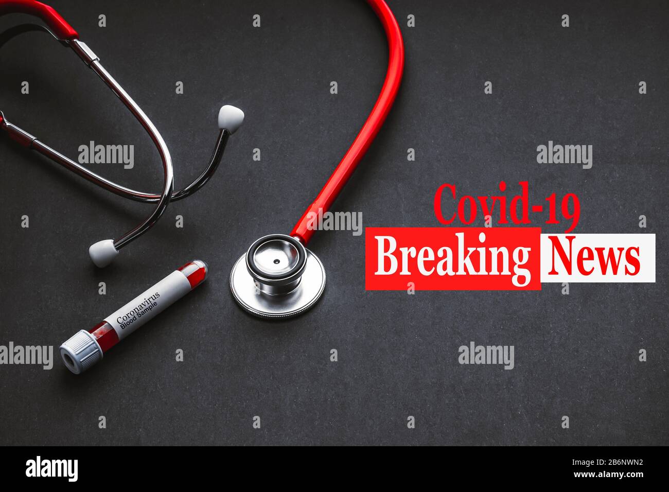 COVID-19 BREAKING NEWS text with stethoscope and blood sample vacuum tube on black background. Covid or Coronavirus Concept Stock Photo
