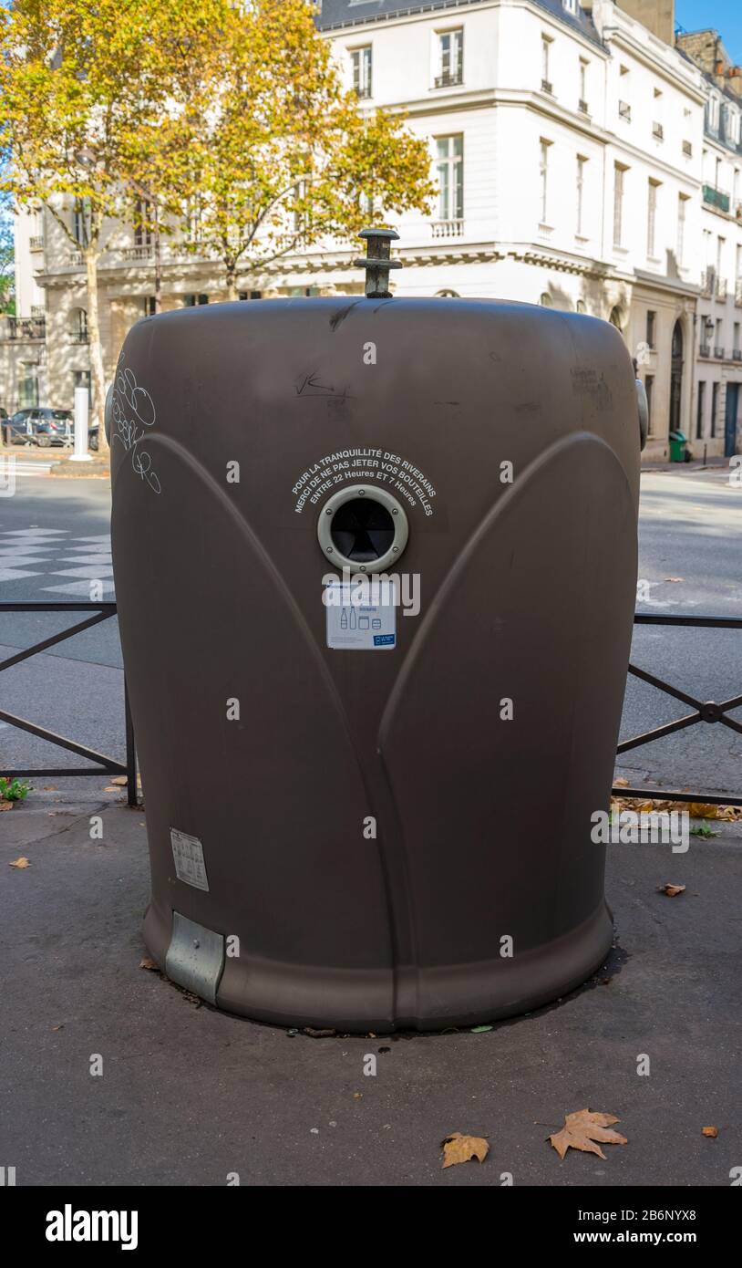 A large brown recycling bin in one of the streets in central Paris